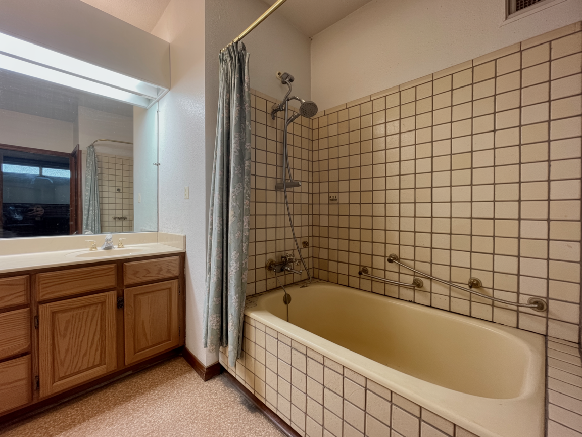 Before: dated 1990s bathroom with beige tub